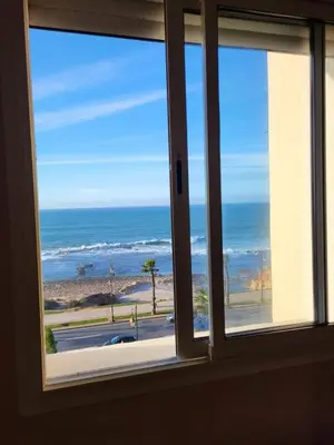 a window with a view of the ocean at Ailes du vent, coucher de soleil,vue sur mer in Rabat