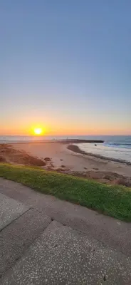 a sunset on the beach with the sun setting on the ocean at Ailes du vent, coucher de soleil,vue sur mer in Rabat