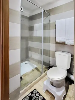a bathroom with a toilet and a shower at Ailes du vent, coucher de soleil,vue sur mer in Rabat