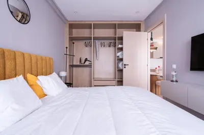a bedroom with a white bed and a television at Premium Stay - Lux Housing Bourgogne in Casablanca