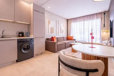 a kitchen and a living room with a table at Premium Stay - Lux Housing Bourgogne in Casablanca