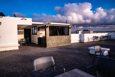 a patio with chairs and tables on a roof at R104- Luxurious Penthouse with Incredible Sea View in Casablanca