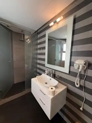 a bathroom with a sink and a mirror at Stunning sea-view apartment 20 in Casablanca