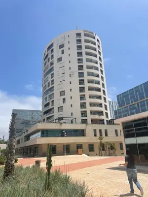 a person standing in front of a tall building at Stunning sea-view apartment 20 in Casablanca
