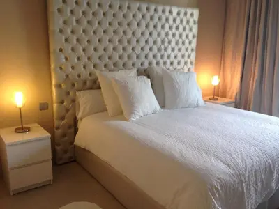 a bedroom with a large white bed with two lamps at Unique in Casablanca