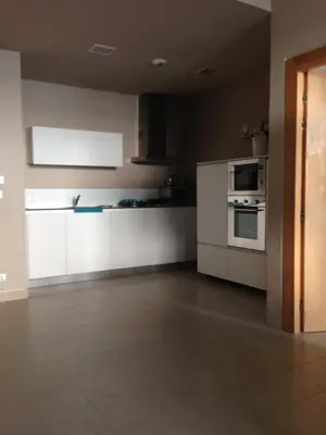 an empty kitchen with white cabinets and appliances at Unique in Casablanca
