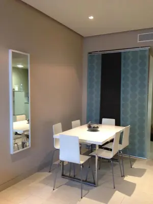 a dining room with a table and chairs and a mirror at Unique in Casablanca