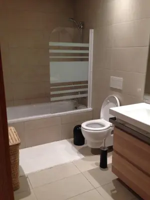 a bathroom with a toilet and a tub and a sink at Unique in Casablanca