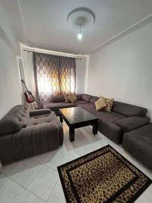 a living room with a couch and a table at Appartement Dadi in Rabat