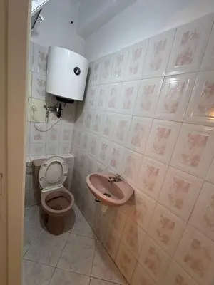 a bathroom with a toilet and a sink at Appartement Dadi in Rabat