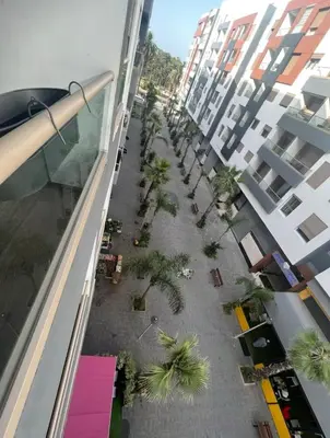 an overhead view of a courtyard with palm trees and buildings at Neuf 3min de la plage au parc avec parking in Mohammedia