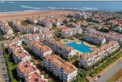 an aerial view of a resort near the beach at Appartement balnéaire équipé in Sidi Rahal