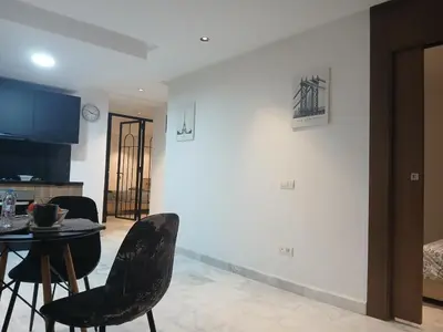 a dining room and kitchen with a table and chairs at Triangle des hôtels in Casablanca