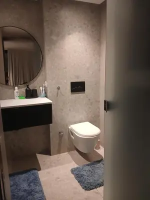 a bathroom with a toilet and a sink and a mirror at Triangle des hôtels in Casablanca