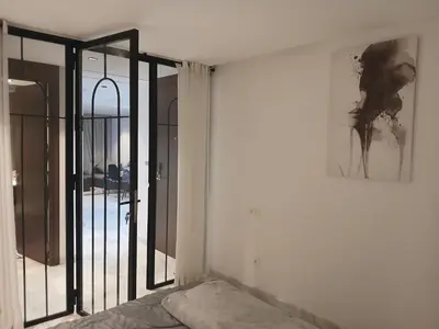 a bedroom with an open door with a mirror at Triangle des hôtels in Casablanca