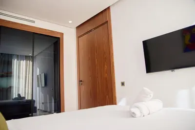 a bedroom with a bed with a television on the wall at Les Princesse superbe Studio neuf moderne in Casablanca