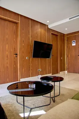 a living room with two tables and a flat screen tv at Les Princesse superbe Studio neuf moderne in Casablanca