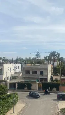 a parking lot with cars parked in front of a building at Spacious Apartment In CIL Casablanca in Casablanca