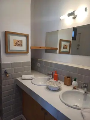 a bathroom with two sinks and a mirror at Spacious Apartment In CIL Casablanca in Casablanca