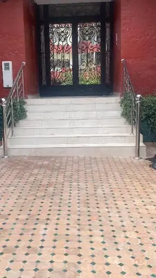 a front door of a building with stairs and a window at Spacious Apartment In CIL Casablanca in Casablanca