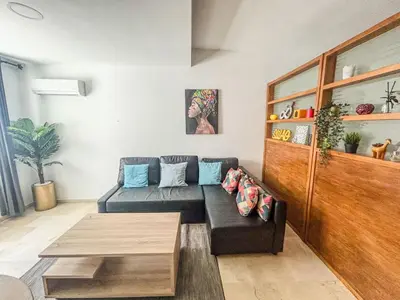 a living room with a couch and a table at Central and Practical Studio - Boulevard d'Anfa in Casablanca