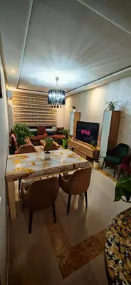 a living room with a table and a couch at Luxury apartment in a prime location and quiet in Casablanca