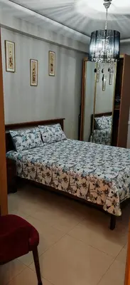 a bedroom with a bed and a chair in it at Luxury apartment in a prime location and quiet in Casablanca