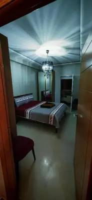 a bedroom with a bed and a chandelier at Luxury apartment in a prime location and quiet in Casablanca