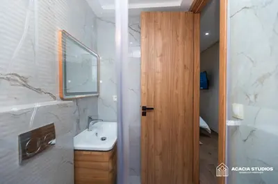 a bathroom with a sink and a mirror at Acacia Studios in Casablanca