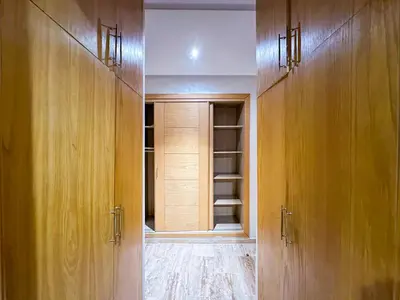 an empty closet with wooden cabinets in a room at Spacious & chic - 3 min from Casa City Finance 