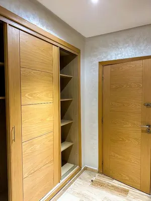 a closet with wooden doors in a room at Spacious & chic - 3 min from Casa City Finance 