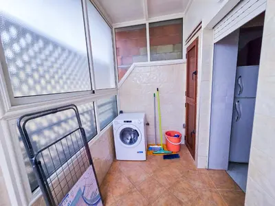 a laundry room with a washer and a washing machine at Spacious & chic - 3 min from Casa City Finance 