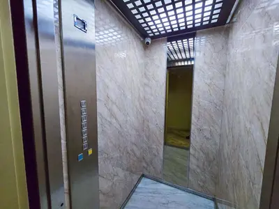 a elevator in a building with a glass door at Spacious & chic - 3 min from Casa City Finance 