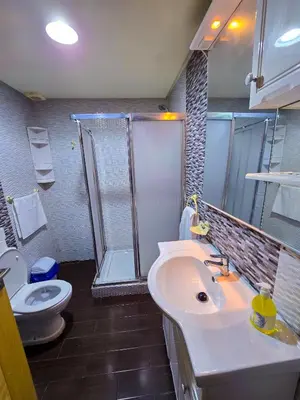 a bathroom with a sink and a shower and a toilet at Spacious & chic - 3 min from Casa City Finance 