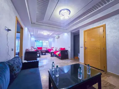 a living room with a couch and a table at Spacious & chic - 3 min from Casa City Finance 