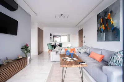 a living room with a couch and a table at Appartement de haut standing au centre ville in Casablanca