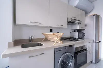 a kitchen with a sink and a washing machine at Appartement de haut standing au centre ville in Casablanca
