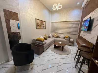 a living room with a couch and a table at Studio cosy connecté in Casablanca
