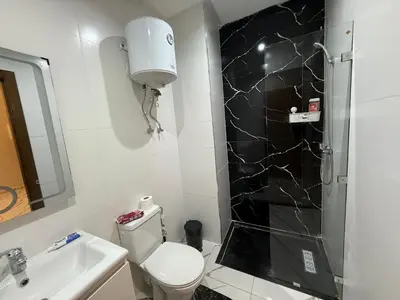 a bathroom with a toilet and a sink and a shower at Studio cosy connecté in Casablanca