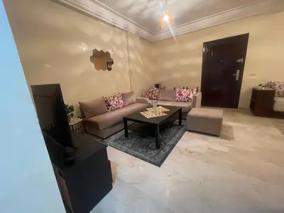 a living room with a couch and a table at Avenue cimetière bourgogne Casablanca in Casablanca
