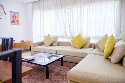 a living room with two couches and a coffee table at Luxueux studio spacieux à racine Casablanca à une minute de twin center in Casablanca