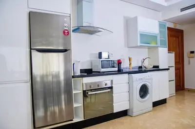 a kitchen with a stainless steel refrigerator and a dishwasher at Luxueux studio spacieux à racine Casablanca à une minute de twin center in Casablanca