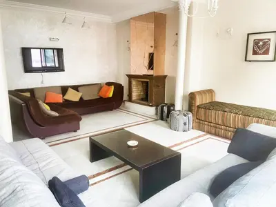 a living room with a couch and a fireplace at Residence kheir in Casablanca