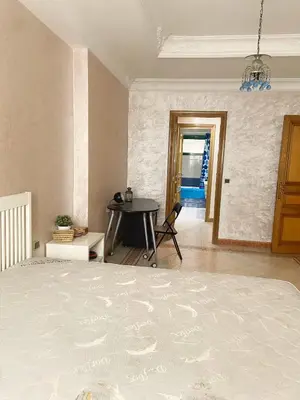 a bedroom with a bed and a table in it at Residence kheir in Casablanca
