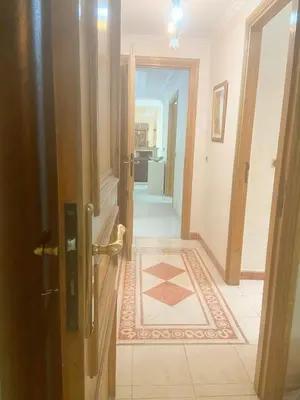 a hallway with a door and a tile floor at Residence kheir in Casablanca