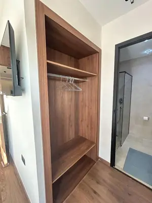 a walk in closet with a wooden door at Appartement luxueux 2 Chambres avec salle de sport et parking in Casablanca