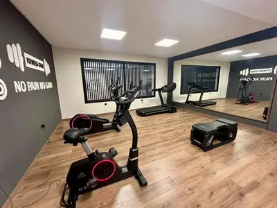 a gym with a treadmill and exercise bike in a room at Appartement luxueux 2 Chambres avec salle de sport et parking in Casablanca
