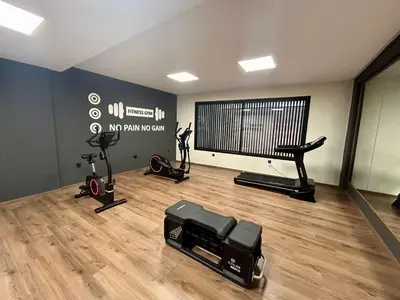 a gym with a treadmill and a large screen at Appartement luxueux 2 Chambres avec salle de sport et parking in Casablanca