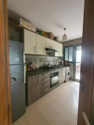 a kitchen with a stainless steel refrigerator and a dishwasher at apart Blanca beach sur mer in Sidi Rahal