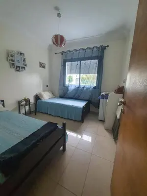 a bedroom with a bed and a window at apart Blanca beach sur mer in Sidi Rahal